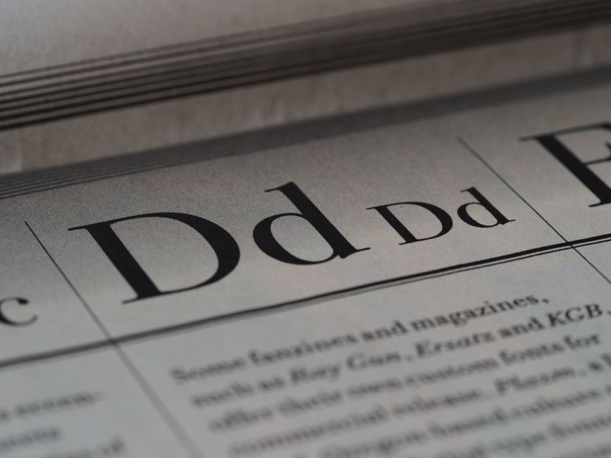 Detailed close-up of a newspaper showing typography and lettering design.